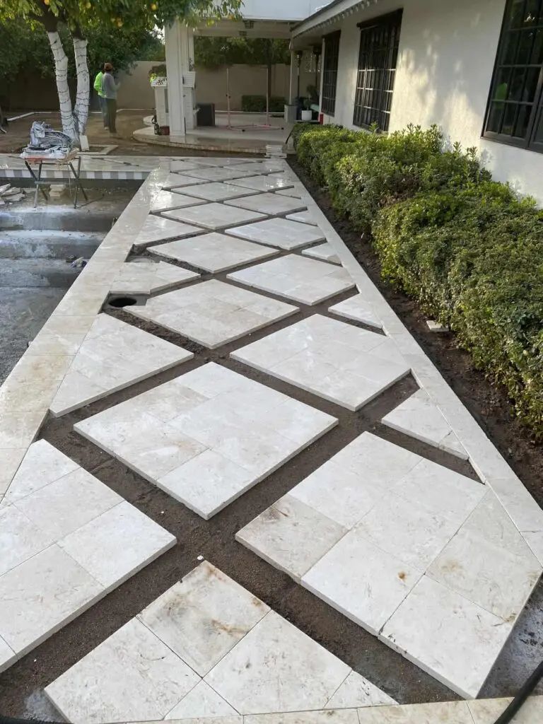 Travertine pool deck pavers laid and ready to have artificial turf installed