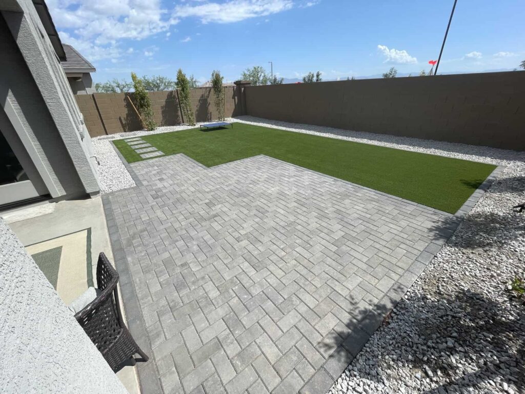 Grey brick paver patio and artificial grass installed at a customers home in Phoenix