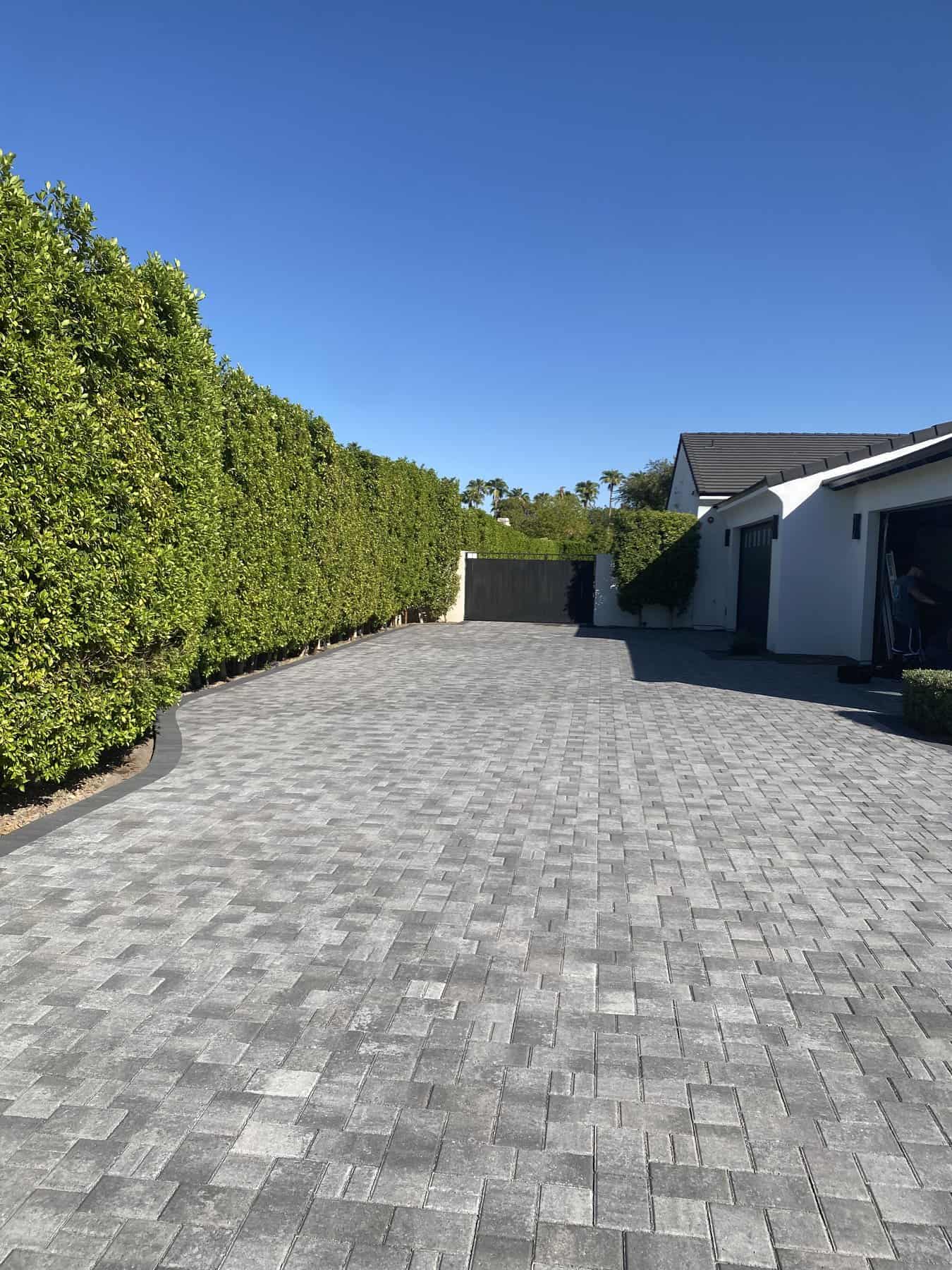 Grey brick belgard paver driveway installed at a home in Scottsdale AZ by Apex Turf