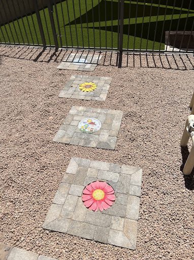 custom pavers with flower inlays crafted and installed by Apex Turf