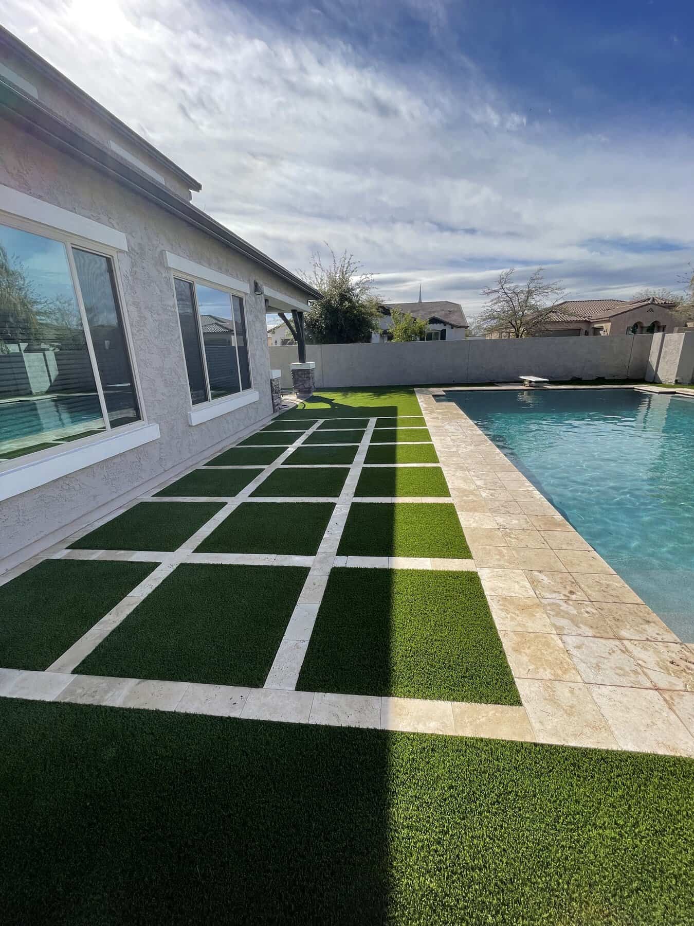 turf and paver pool deck in Scottsdale. Installed next to a pool by Apex Turf
