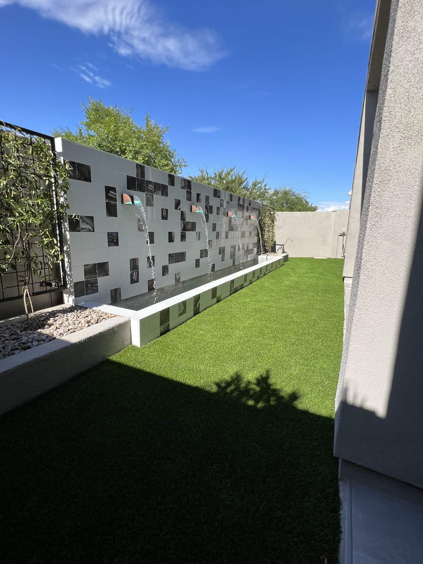 water feature with 4 spouts and a hardscaped garden bed installed by Apex Turf in Tucson