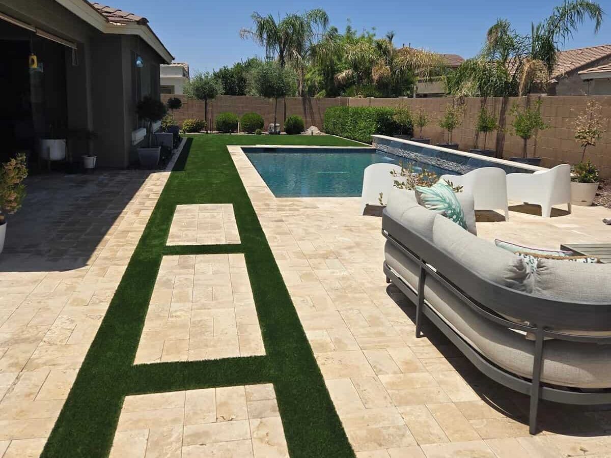 Shellstone paver patio and pool deck with seating and a blue pool in a Phoenix backyard