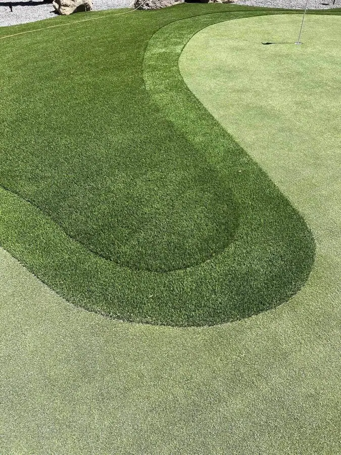 Synthetic turf golf green with 3 different pile heights to create a fringe area on the putting surface