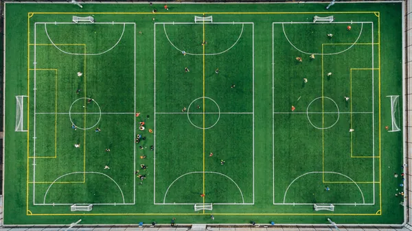 birds eye view of three artificial grass soccer fields next to each other