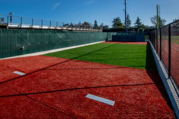 Red and green turf in a baseball bullpen with pitchers pads